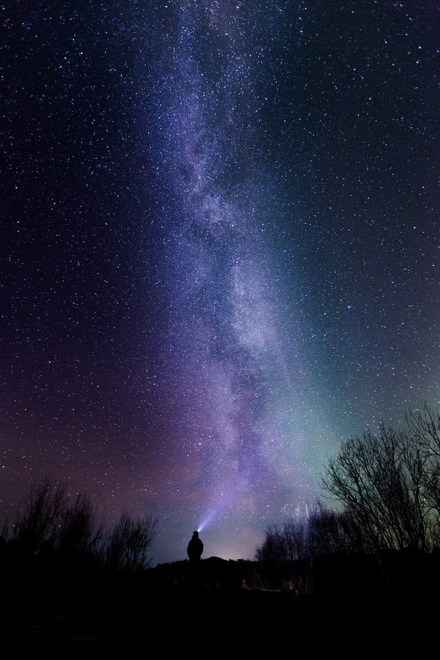 silhouette photography of person under starry sky