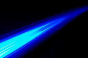 Blue light beam on black background